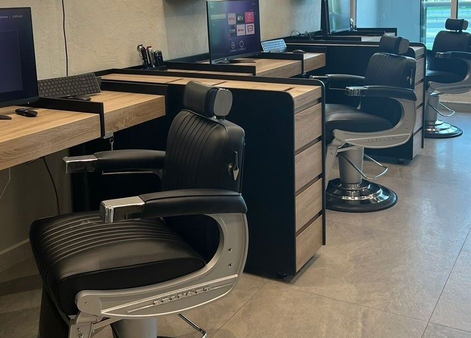 Modern barber chairs at New Look Business in Dubai, Dubai, AE, highlighting sleek design and comfort.