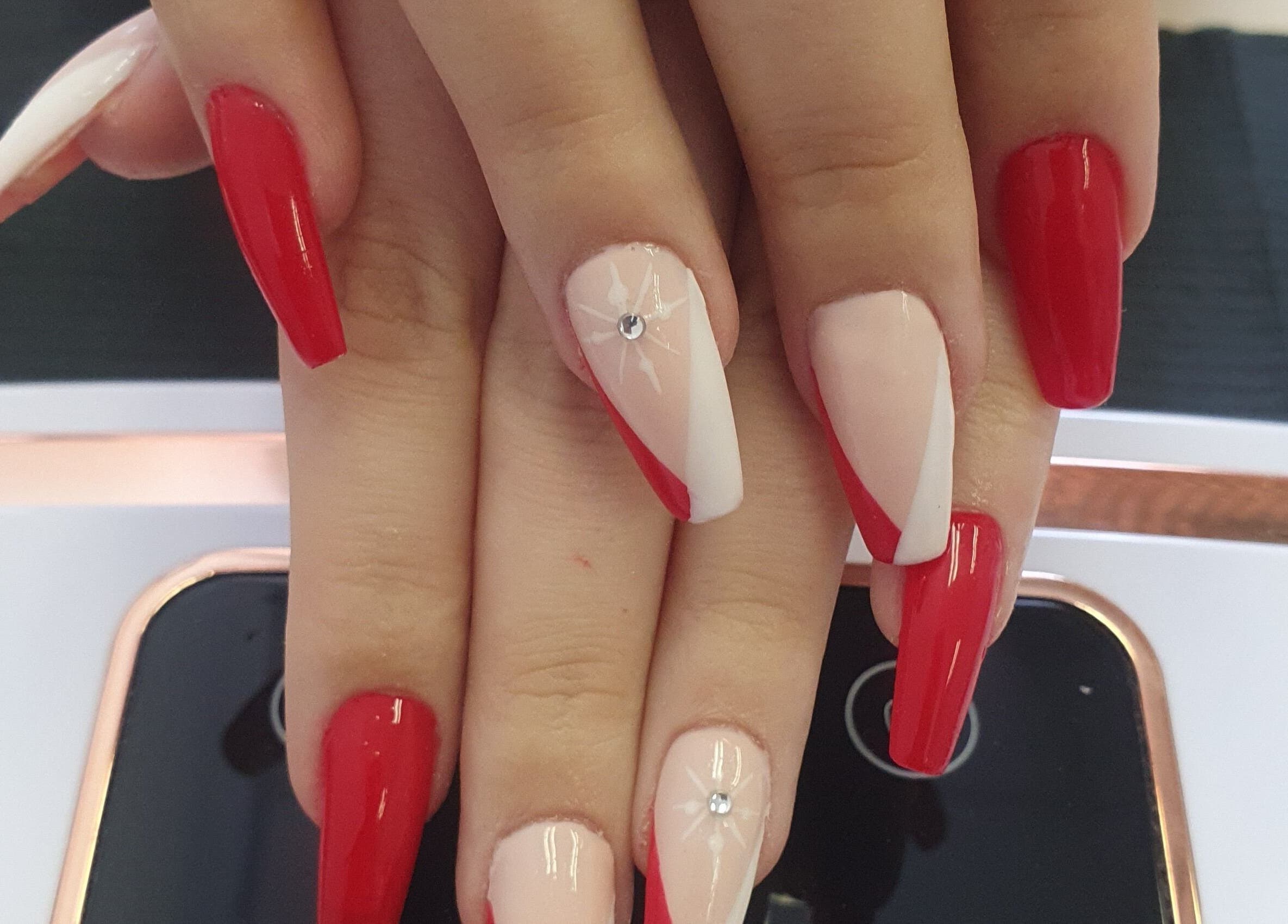 Elegant red manicure with gem accents at BeBe, Cape Town, Western Cape, ZA.