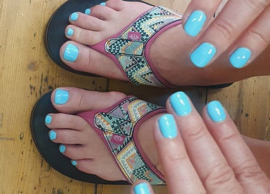 Bright aqua manicure and pedicure at BeBe, Cape Town, Western Cape, ZA. Hands and feet with turquoise nails.