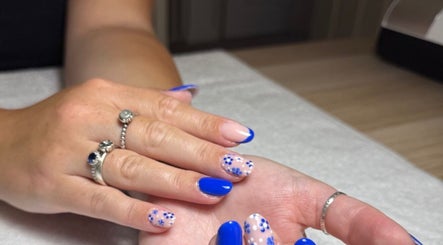 Elegant blue floral nail art at The Nail Vault in Plymouth, England, GB, showcasing creativity and style.