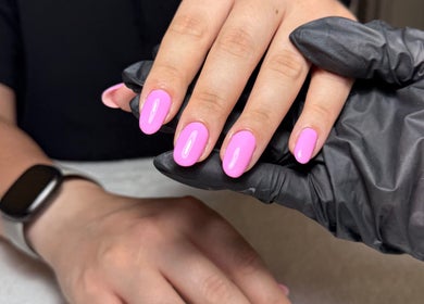 Bright pink manicure at The Nail Vault in Plymouth, England, GB, showcasing expert nail care.