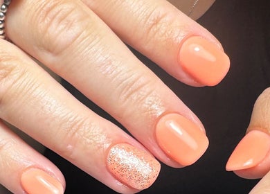 Coral nail art with glitter accent at The Nail Vault, Plymouth, England, GB.