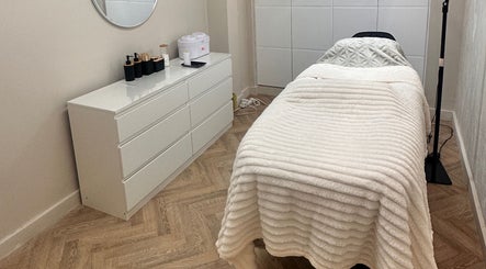 Cozy treatment room at PG Beauty Bar, Dewsbury, England, GB with plush bed and modern decor.