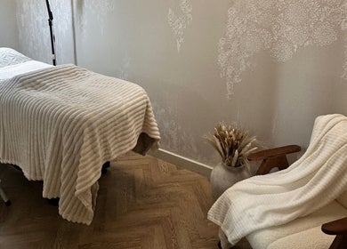 Cozy treatment room at PG Beauty Bar in Dewsbury, England, GB with a plush bed and relaxing decor.