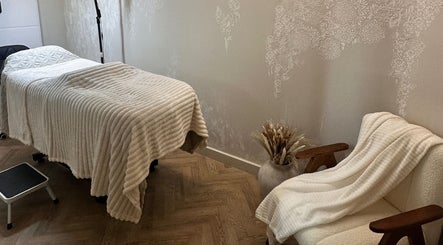 Cozy treatment room at PG Beauty Bar in Dewsbury, England, GB with a plush bed and relaxing decor.