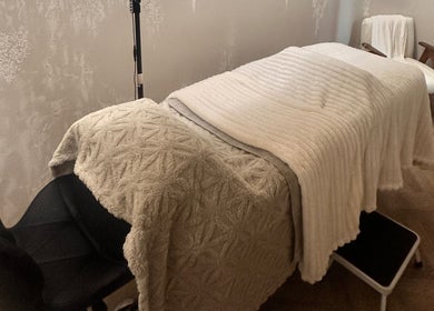 Cozy treatment room at PG Beauty Bar, Dewsbury, England, GB with plush bedding and modern decor.