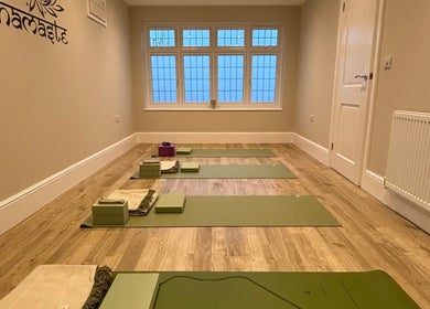 Yoga mats neatly arranged at Claire Elliott Coaching & Yoga, Buntingford, England, GB. Peaceful wellness venue.