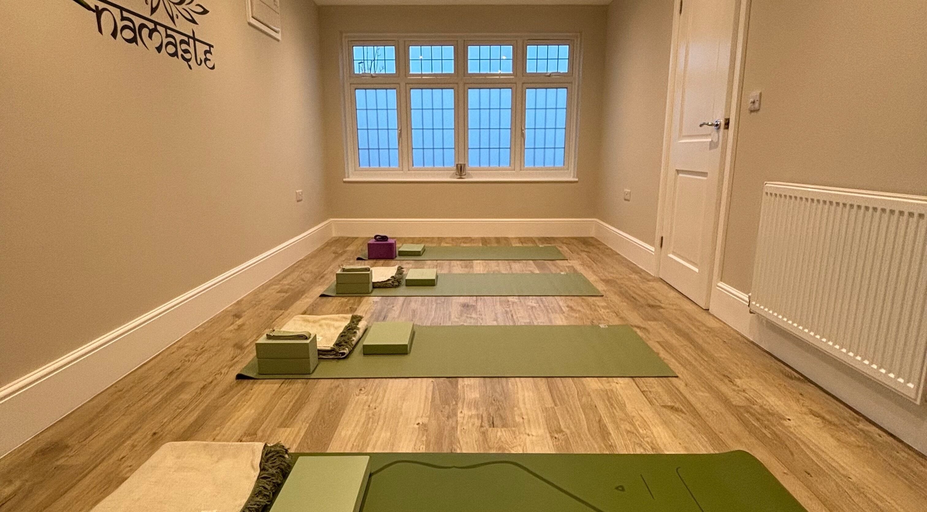 Yoga mats neatly arranged at Claire Elliott Coaching & Yoga, Buntingford, England, GB. Peaceful wellness venue.