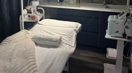 Relaxing treatment room at 27 Skin, Lingfield, England, GB, featuring cozy bed and modern equipment.