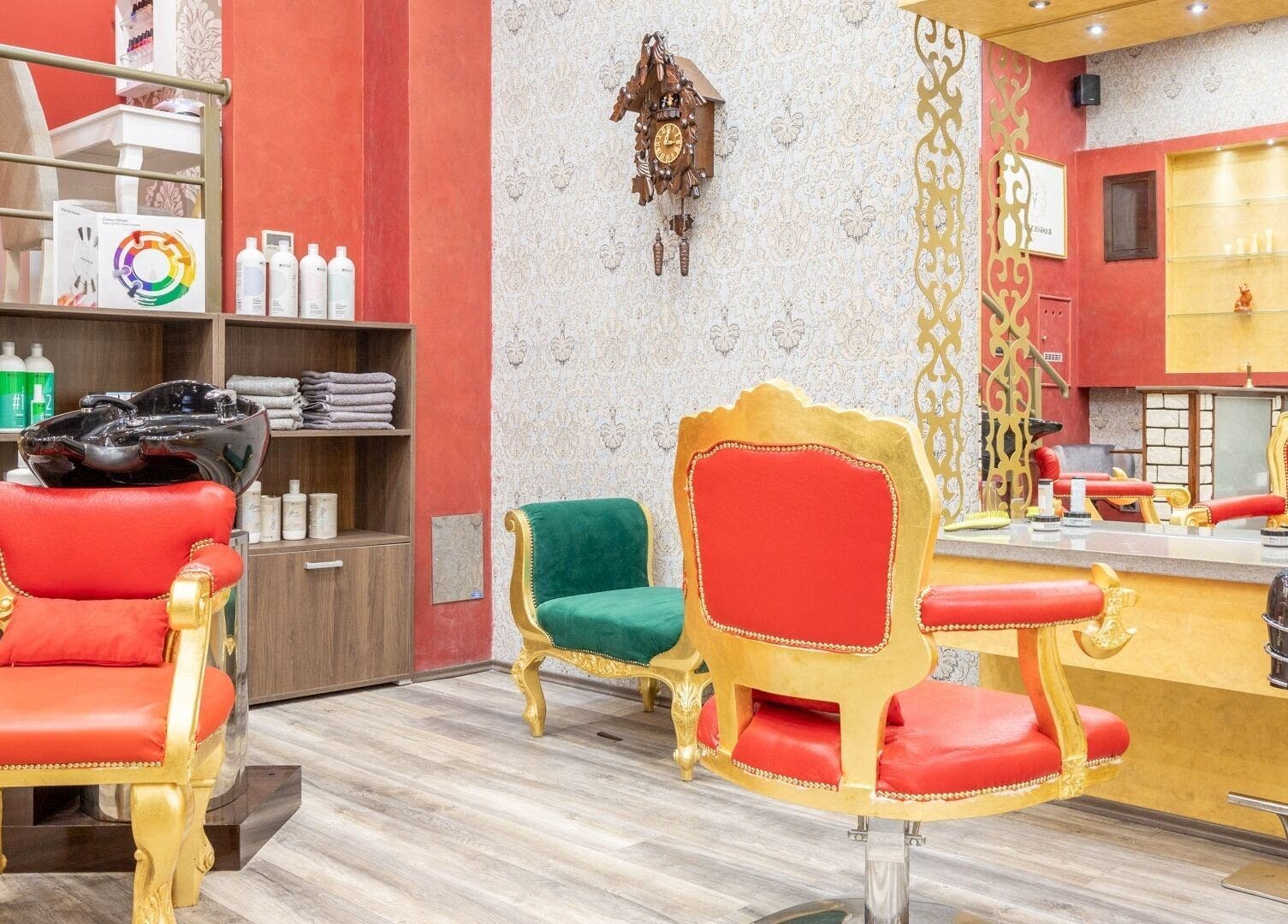 Elegant interior of Raskoljnikov Beauty Studio, Београд, RS with vibrant red and gold decor.