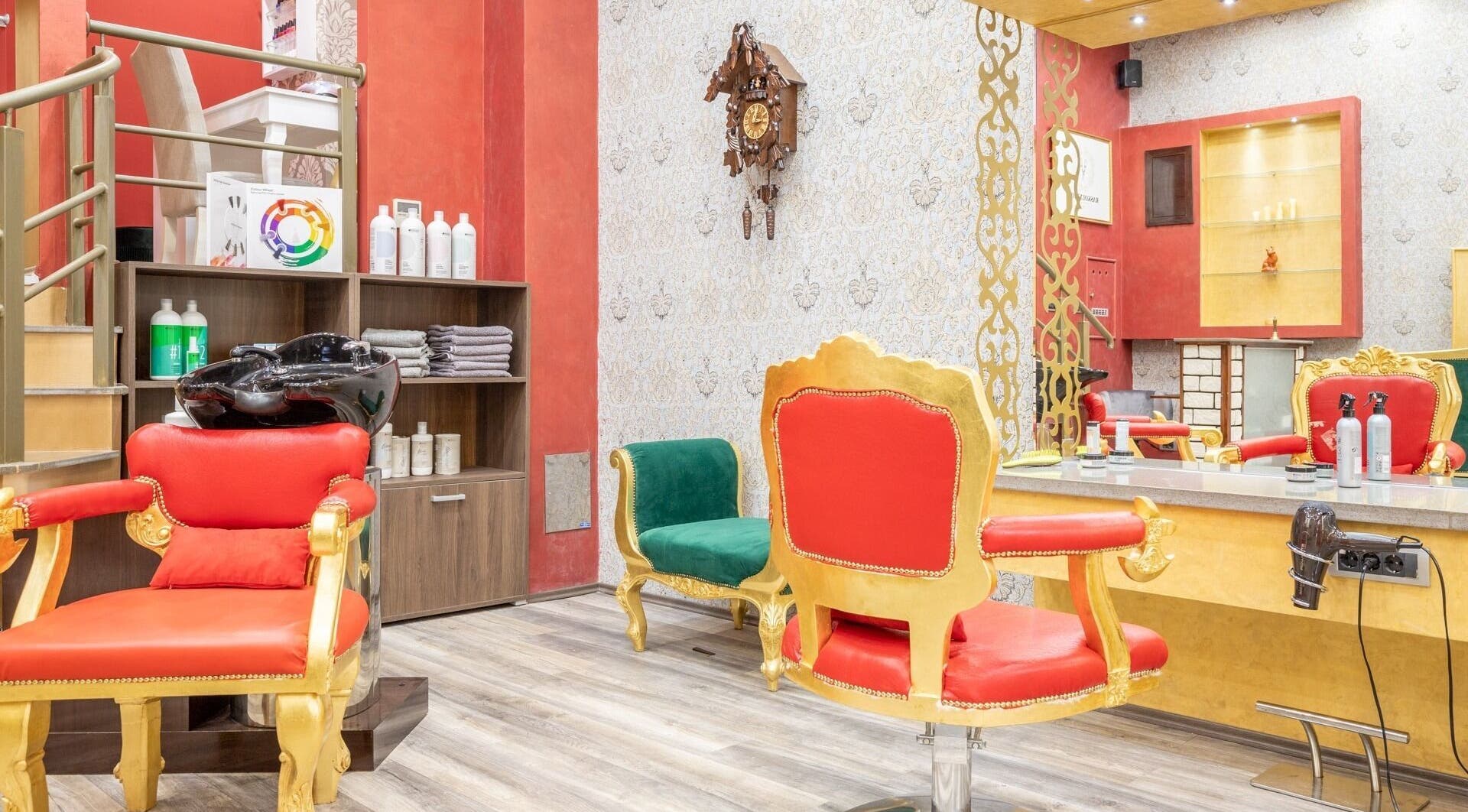 Elegant interior of Raskoljnikov Beauty Studio, Београд, RS with vibrant red and gold decor.