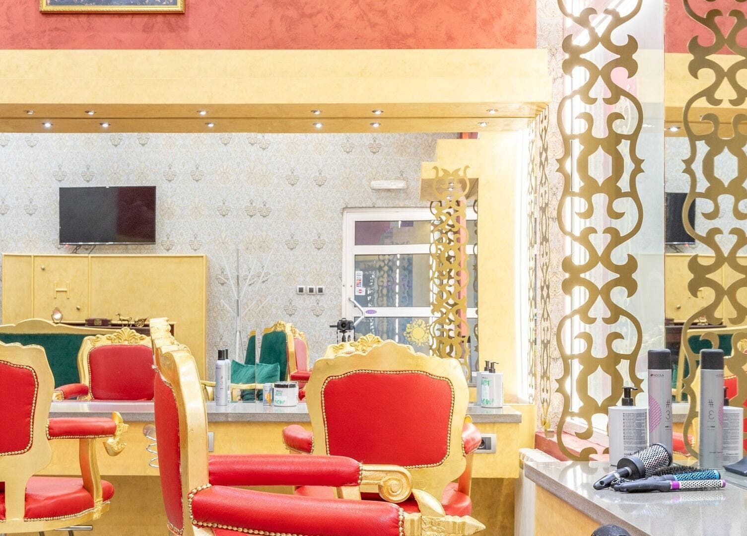 Luxurious salon interior with red and gold chairs at Raskoljnikov Beauty Studio, Београд, RS.