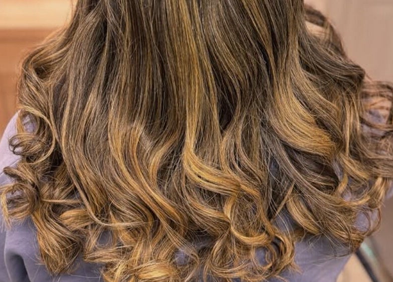 Elegant curled hairstyle at Elegance Studio, Ballygar, County Galway, IE, showcasing a blend of golden hues.