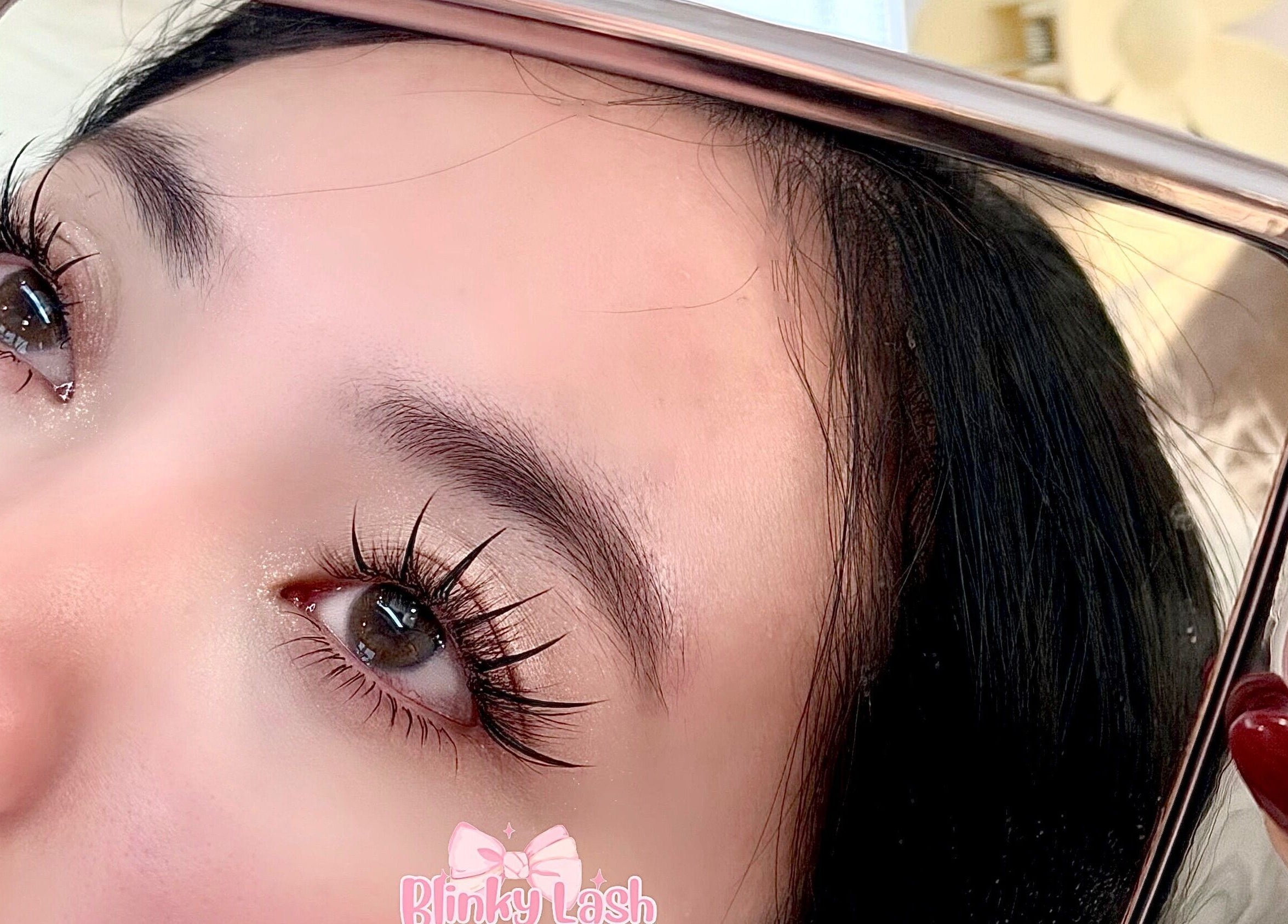 Close-up of enhanced eyelashes reflected in a mirror at Blinky Lash, Calgary, Alberta, CA.