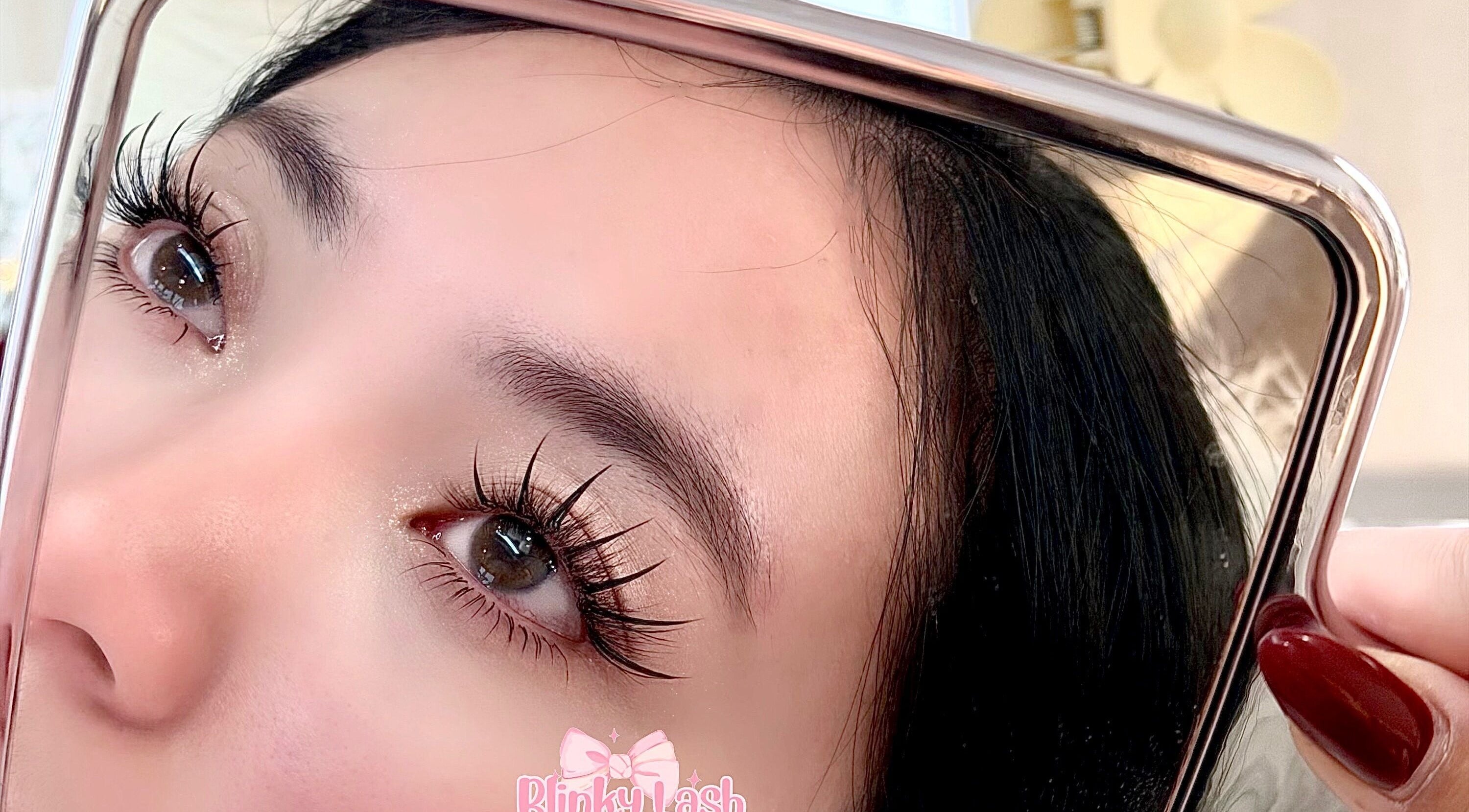 Close-up of enhanced eyelashes reflected in a mirror at Blinky Lash, Calgary, Alberta, CA.