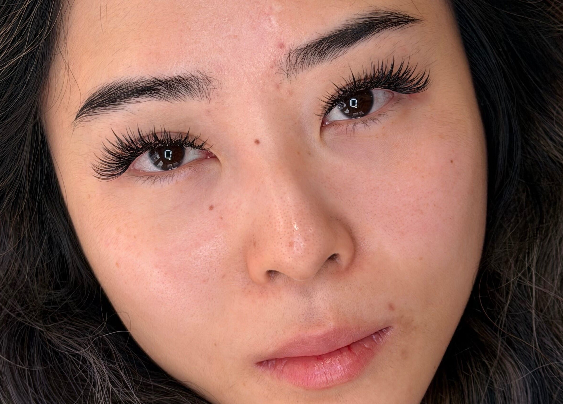 Close-up of expertly applied lashes at Blinky Lash, Calgary, Alberta, CA showcasing long, voluminous lashes.