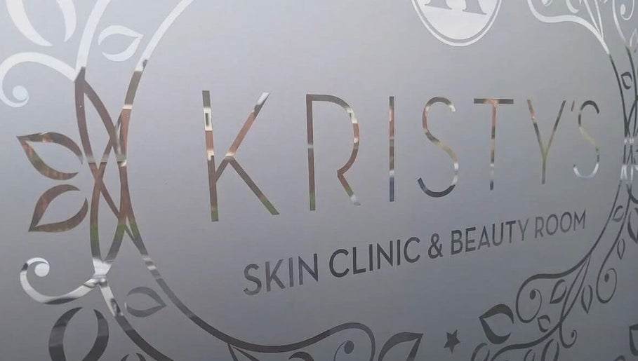 Elegant signage of Kristys Beauty Whitby, located in Whitby, England, GB, with decorative floral patterns.