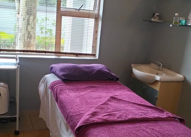 Relaxing massage room at Maxima Sports Massage, Pretoria, Gauteng with soft lighting and a treatment bed.