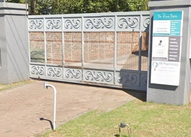 Ornate gate at Maxima Sports Massage, Pretoria, Gauteng, ZA, featuring elegant metalwork and signage.