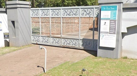 Ornate gate at Maxima Sports Massage, Pretoria, Gauteng, ZA, featuring elegant metalwork and signage.