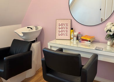 Modern salon chair and wash station at Lorna’s Luxe Hair, Great Dunmow, England, GB, with stylish decor.