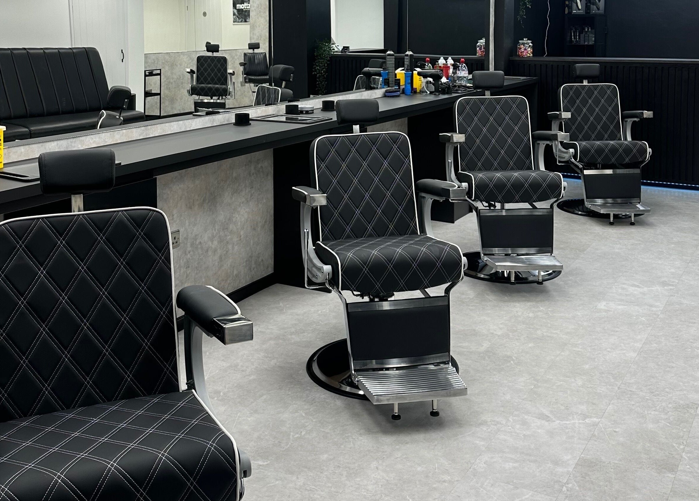 Modern barber chairs at Mattz Barbers in Birmingham, England, GB. Stylish and comfortable grooming space.