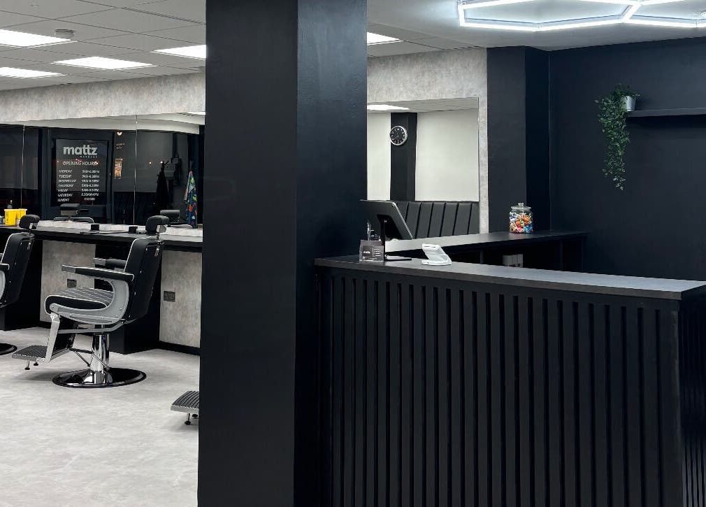 Interior of Mattz Barbers, Birmingham, England, featuring sleek chairs and a stylish reception desk.