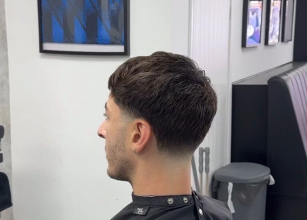 Stylish haircut at Mattz Barbers, Birmingham, England, GB, showcasing a modern fade in a sleek barbershop setting.