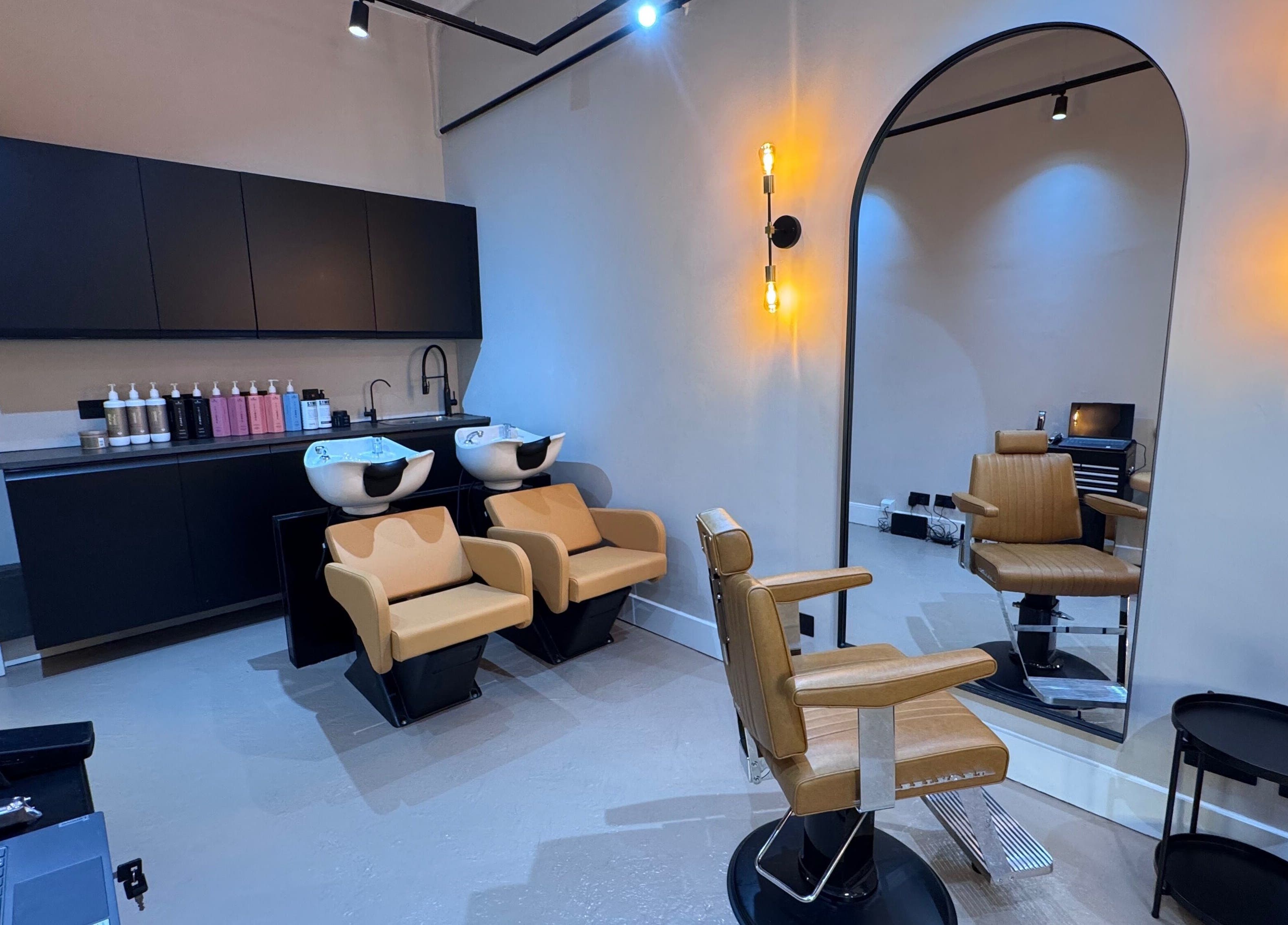 Modern salon interior at Yss Studio in London, England, GB with stylish seating and chic decor.