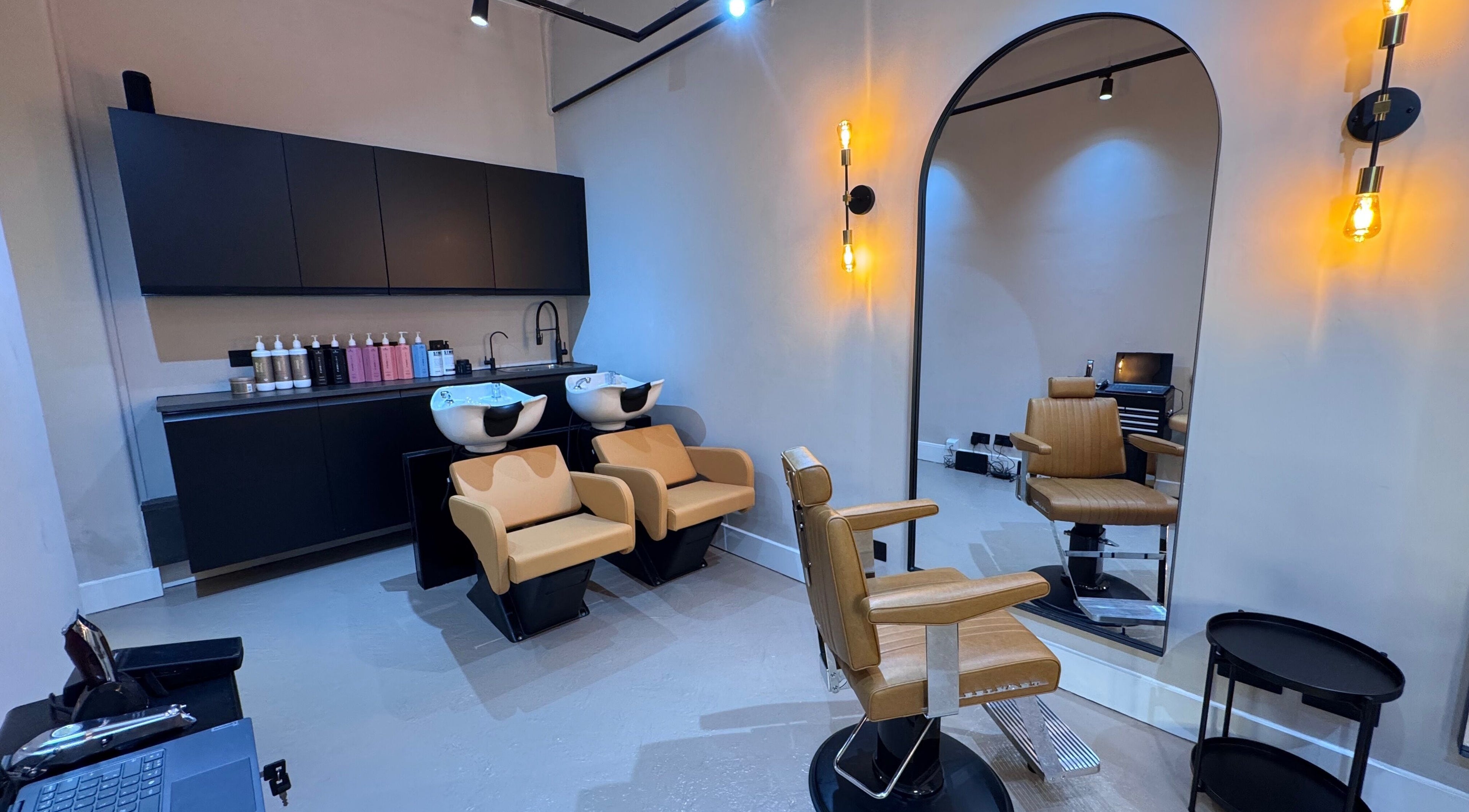 Modern salon interior at Yss Studio in London, England, GB with stylish seating and chic decor.