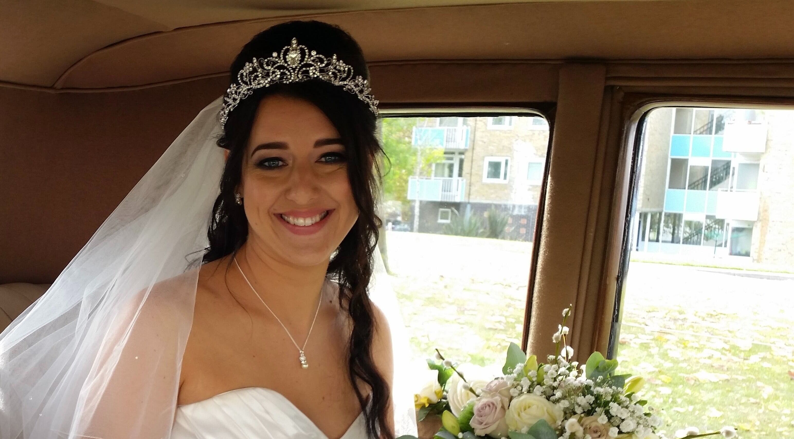 Smiling bride with tiara and bouquet at Rita DeSario Make-Up Artist in Southampton, England, GB.