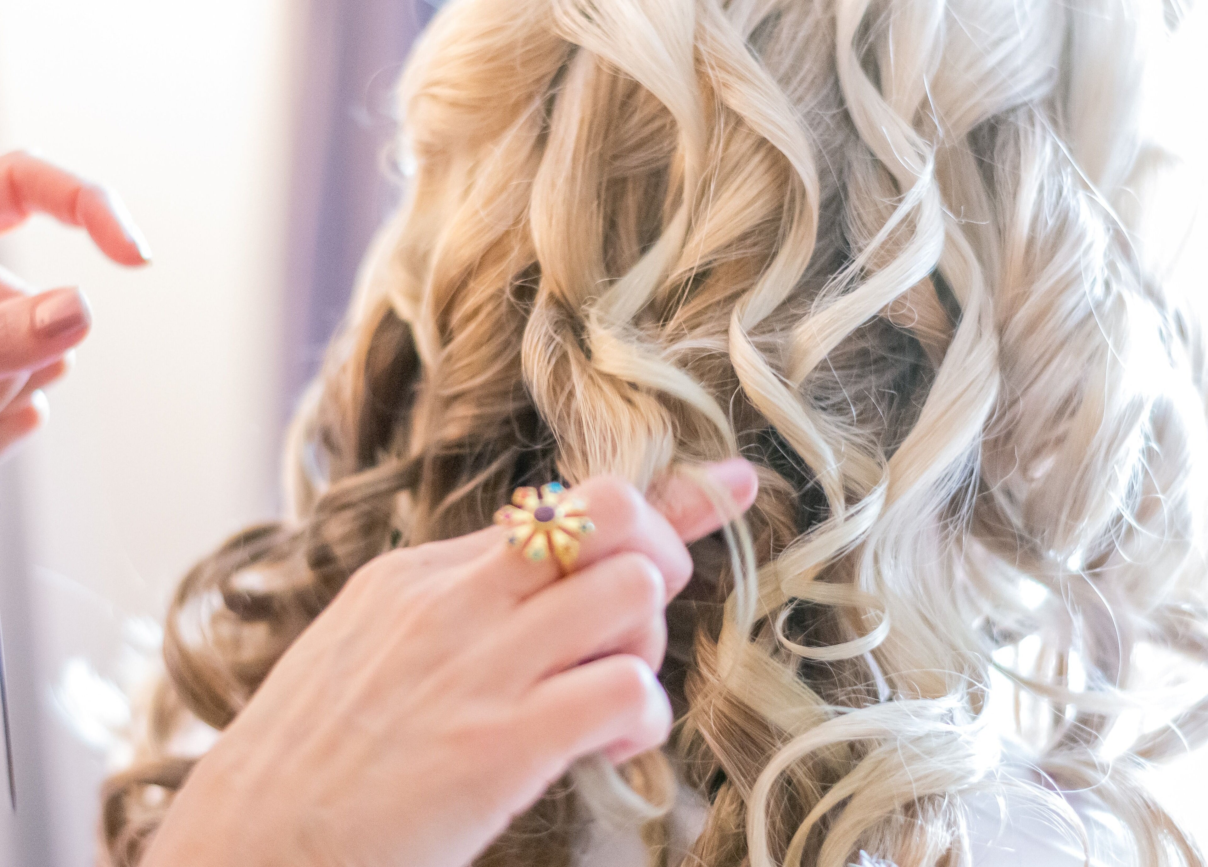 Stylist crafting elegant curls at Rita DeSario Make-Up Artist, Southampton, England, GB.
