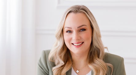 Smiling professional at Erin Harrington Beauty in Dubai, AE, exemplifying elegance and expertise.