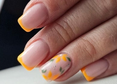 Elegant Nails in Cardiff, Wales, GB showcases vibrant sunflower nail art with yellow tips.