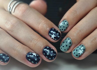 Nail art with blue polka dots and stars at Elegant Nails, Cardiff, Wales, GB.