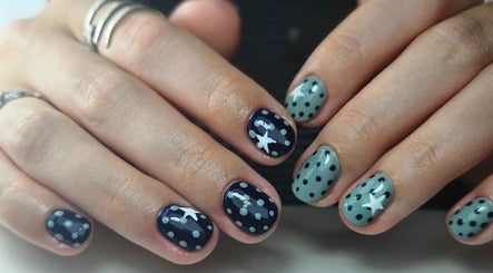 Nail art with blue polka dots and stars at Elegant Nails, Cardiff, Wales, GB.