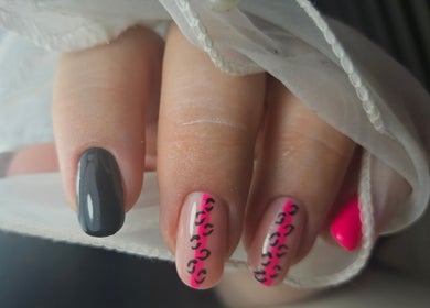 Stylish black and pink nail art at Elegant Nails, Cardiff, Wales, GB, featuring intricate designs.