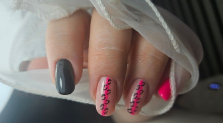 Stylish black and pink nail art at Elegant Nails, Cardiff, Wales, GB, featuring intricate designs.
