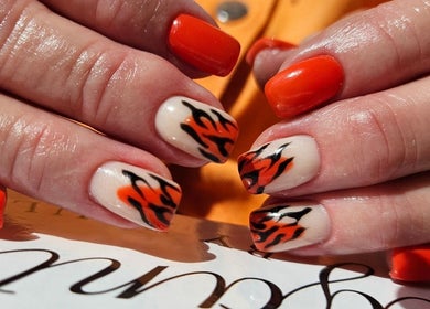Bold flame nail art by Elegant Nails, Cardiff, Wales, GB, showcasing vibrant orange and black design.