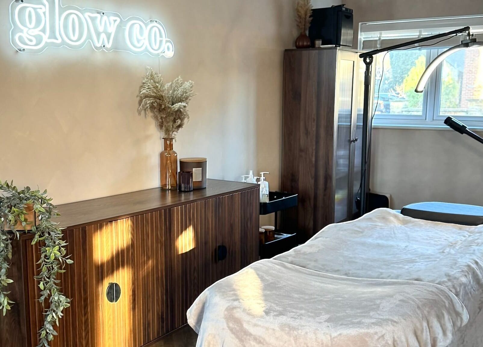Relaxing treatment room at Glow Co. Skincare, Walgrave, GB with cozy decor and gentle lighting.