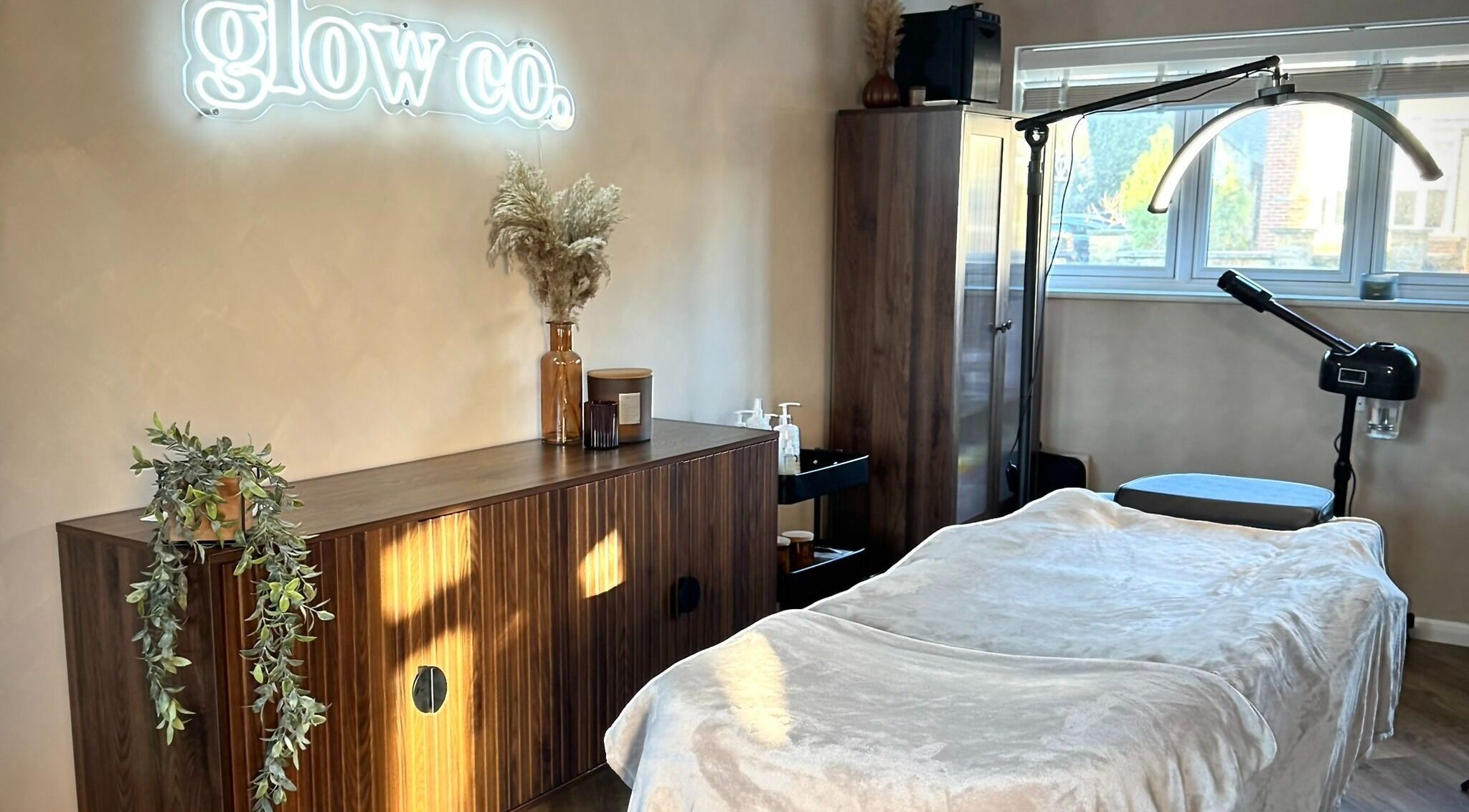Relaxing treatment room at Glow Co. Skincare, Walgrave, GB with cozy decor and gentle lighting.