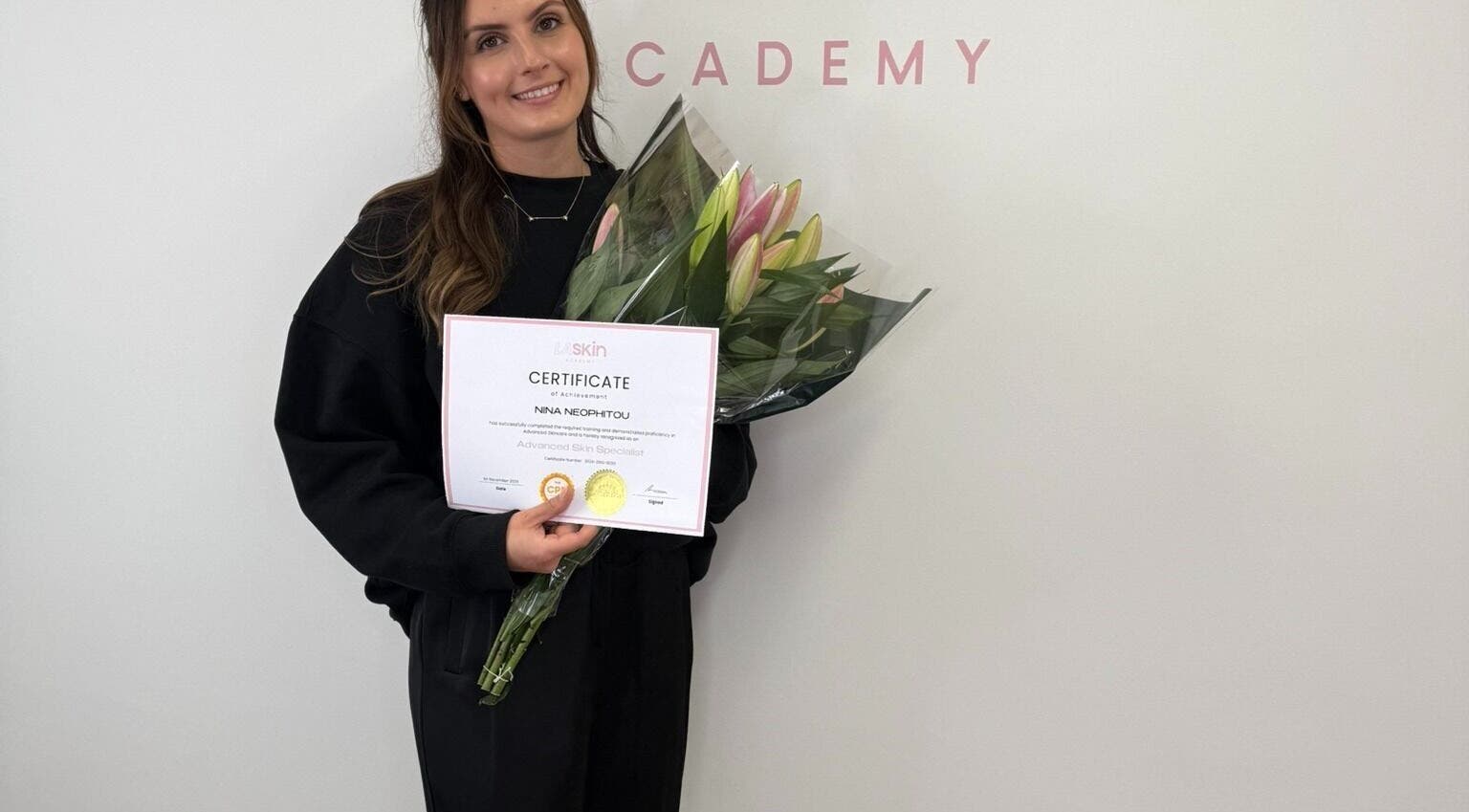 Glow Co. Skincare graduate holding certificate and flowers in Walgrave, GB.