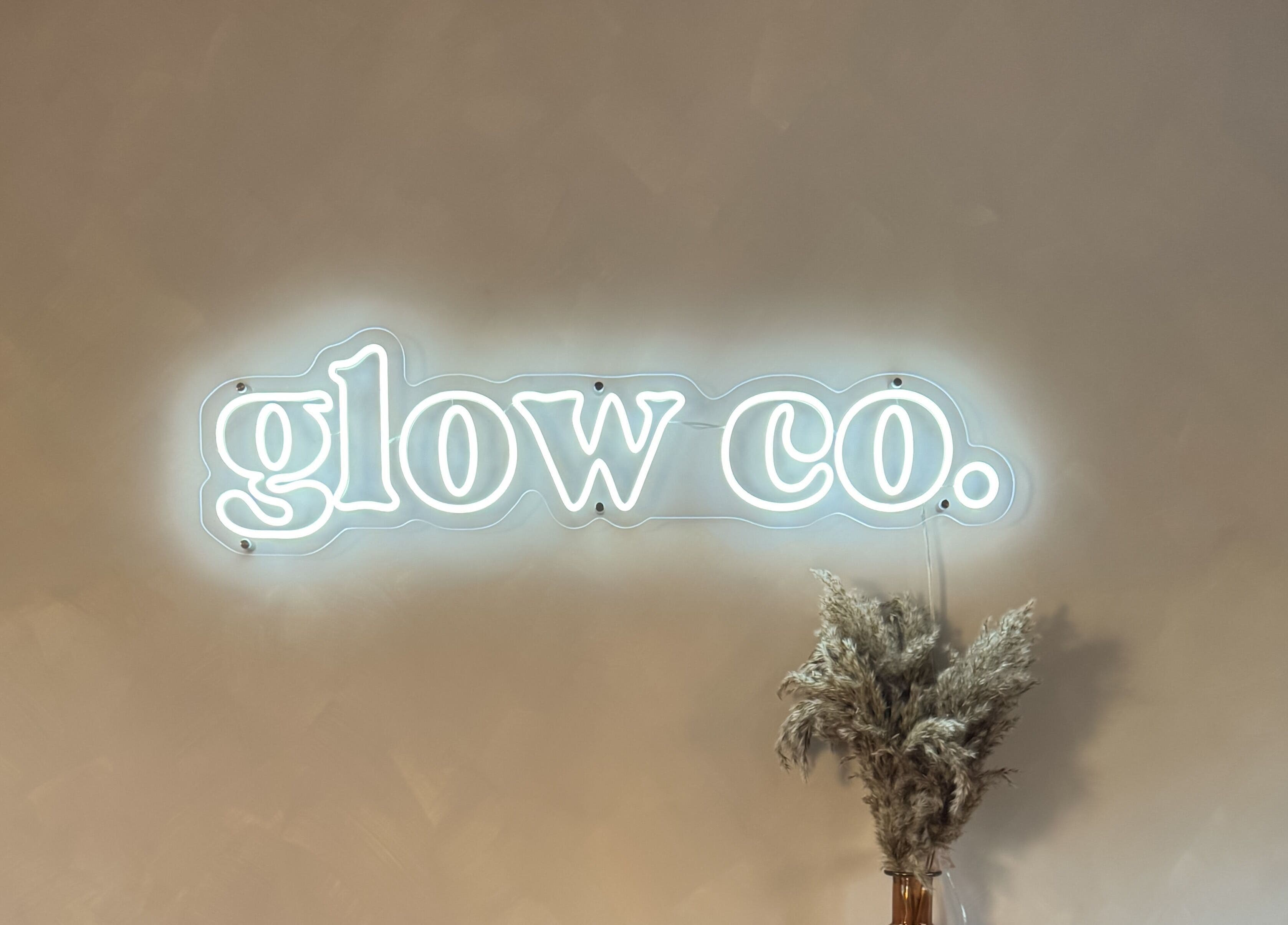 Illuminated Glow Co. Skincare sign with pampas grass decor in Walgrave, GB.