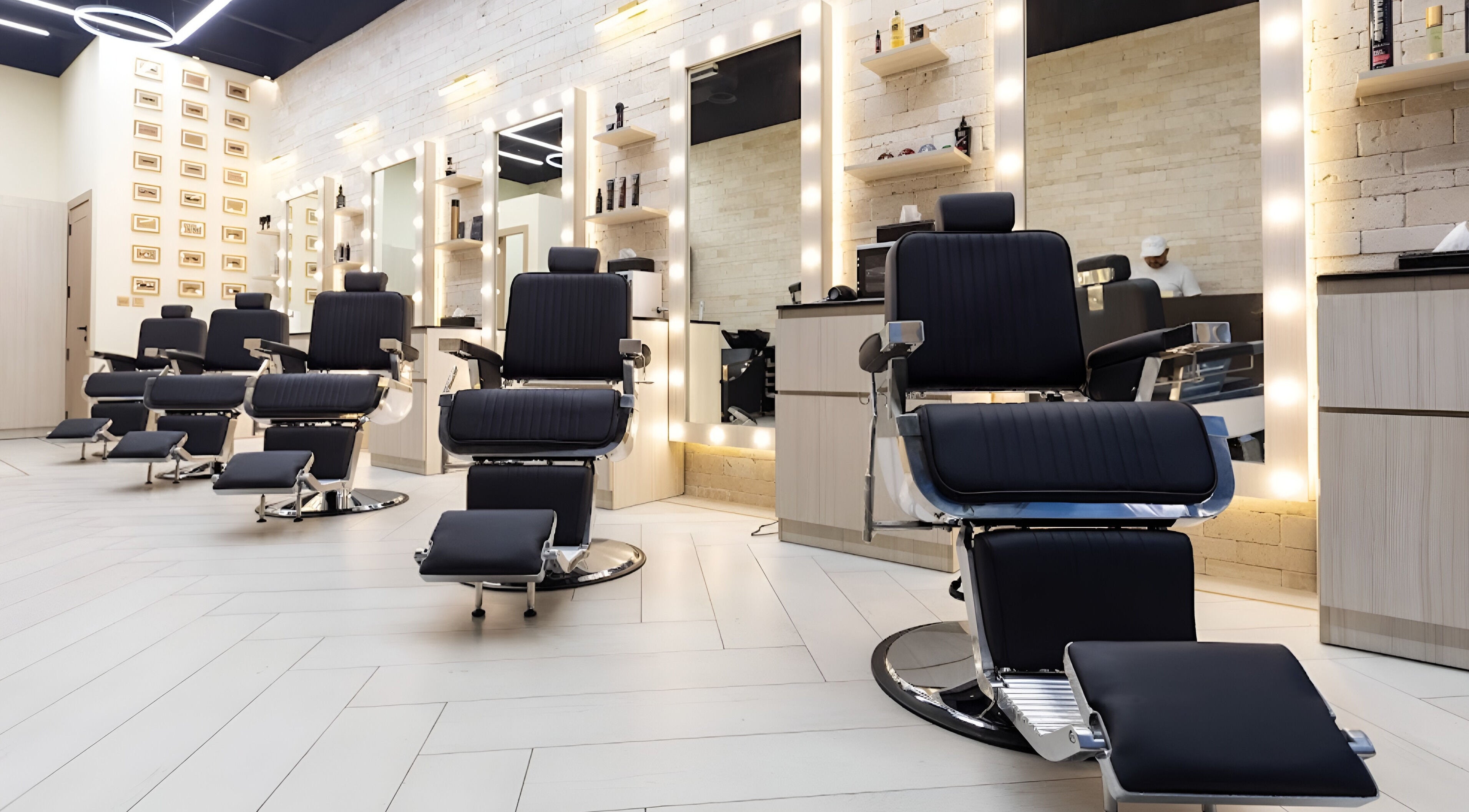 Modern interior of Tache Barbershop in دبي, دبي, AE featuring sleek barber chairs and illuminated mirrors.