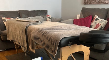 Comfortable massage area at Pollock Sports Therapy in Coleraine, Northern Ireland, GB, with cozy pillows and blankets.