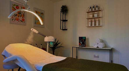 Cozy treatment room at Essential Recovery, Yarm, England, GB, featuring a massage bed and skincare products.