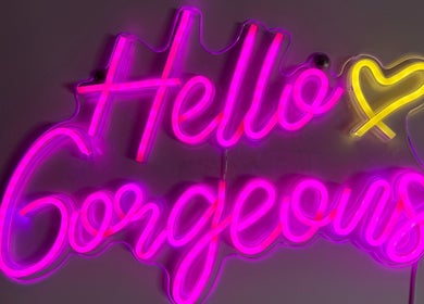 Vibrant neon sign saying 'Hello Gorgeous' at Comfort Wax Studio, Edmonton, Alberta, CA.