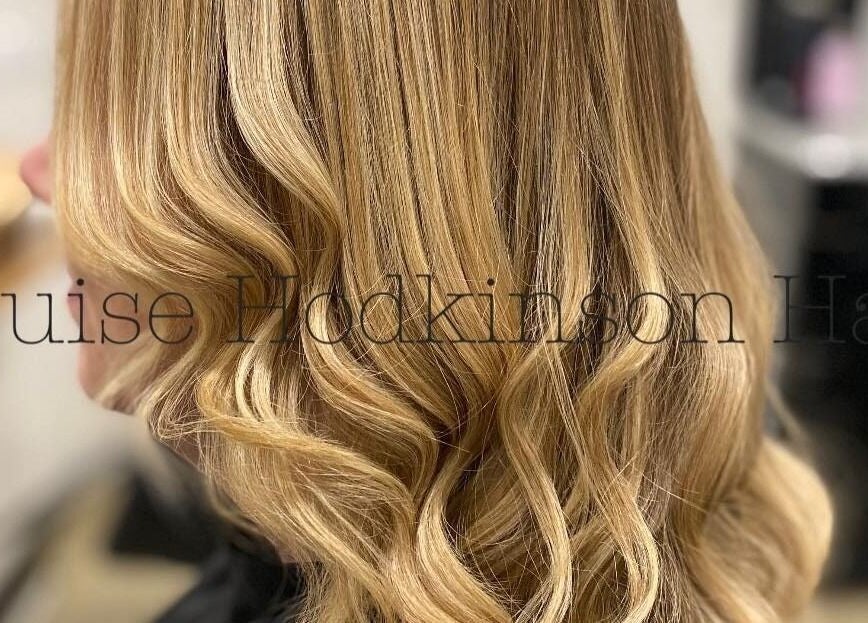Stylish wavy blonde hair styled at Louise Hodkinson Hair, Yeerongpilly, Queensland, AU.