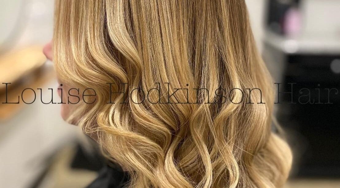 Stylish wavy blonde hair styled at Louise Hodkinson Hair, Yeerongpilly, Queensland, AU.