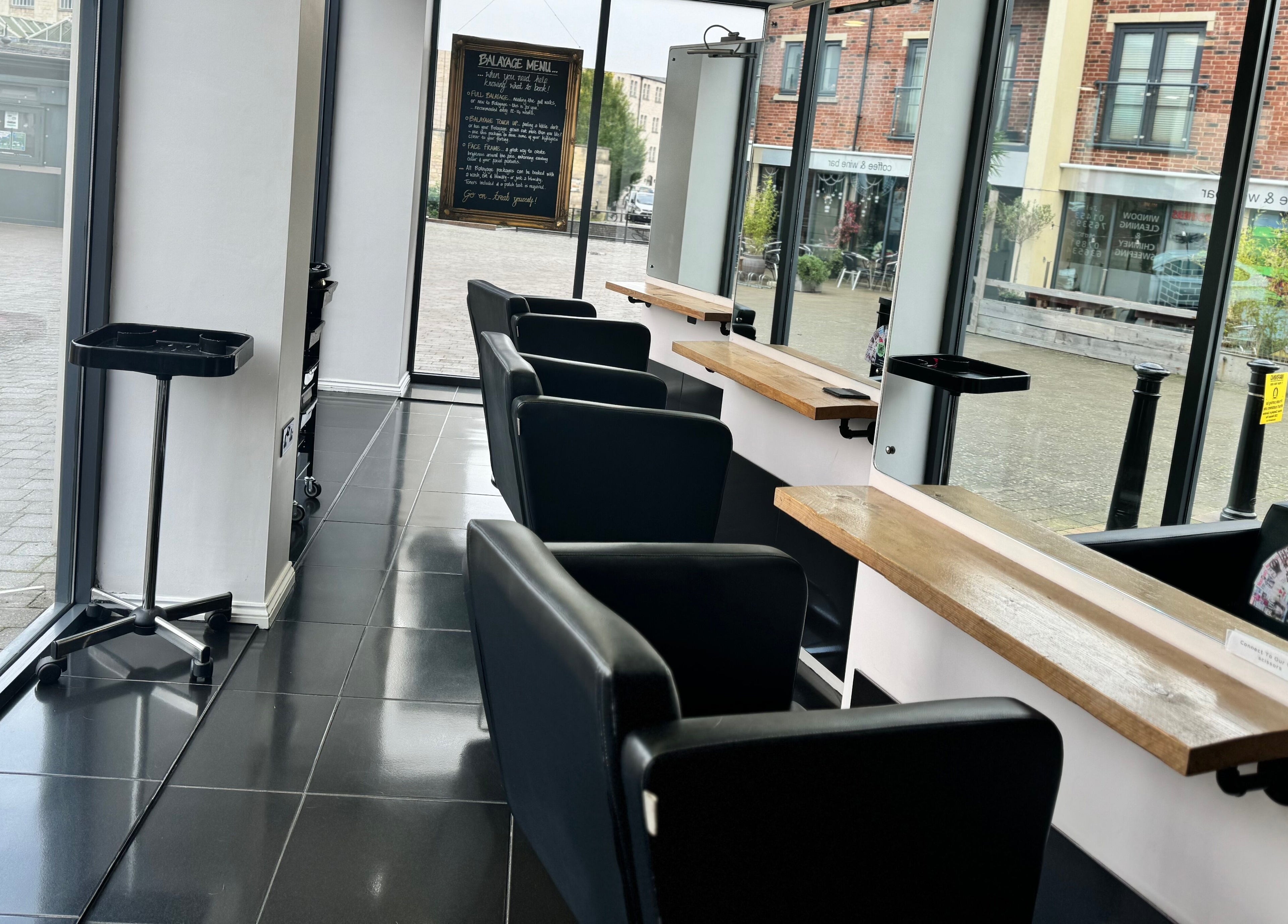 Chic interior of Studio 13 “A Salon Collective for Independent Stylists“, Ebley, England, GB with elegant salon chairs.